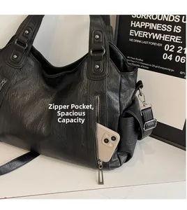 Detail view of the vintage leather tote bag featuring a functional side zipper pocket