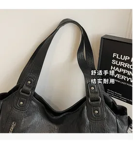 Close-up of durable PU leather tote bag handles with reinforced metal rivets and texture