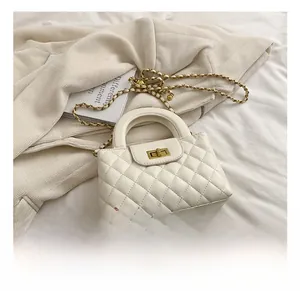 Detail view of quilted leather handbag with gold square twist lock and chain strap