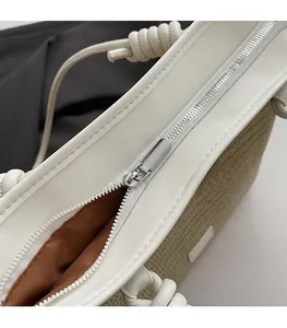 Close-up of smooth metal zipper and woven texture on a minimalist tote bag