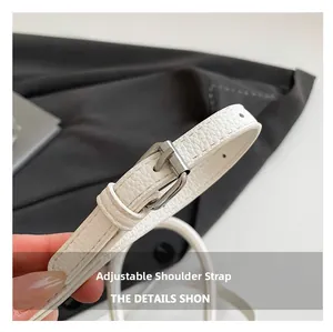 Detail of adjustable white litchi grain leather strap with silver metal buckle and eyelets