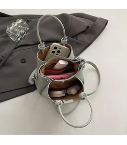 Interior view showing three compartments and large capacity of this textured bucket bag