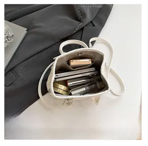 Top macro view of white bucket bag showing large inner capacity for daily essentials