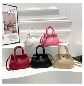 Detail of mini tote bags in various colors showing pebble leather texture and metal buckles