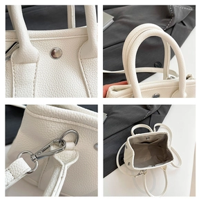 Detailed views of white litchi pattern leather bucket bag handles and silver hardware