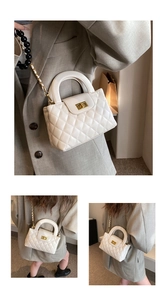 Detail of white quilted handbag featuring golden twist lock and black beaded chain strap