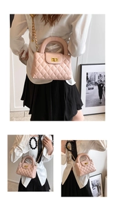 Detail of light pink quilted handbag with gold square lock and elegant chain strap