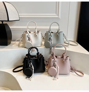 Detail of four colorful bucket bags with knot handles and matching round coin purses
