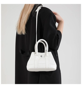 Detail of white lychee pattern leather bucket bag with silver button and dual handles