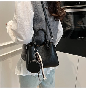 Black litchi pattern bucket bag with a detachable mini round pouch and knotted handle