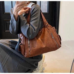 Mirror selfie showing a large brown vintage tote bag with double front zip pockets