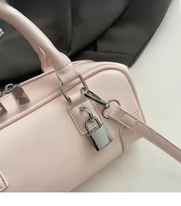 Detail of pink leather pillow bag showing silver hardware and decorative padlock