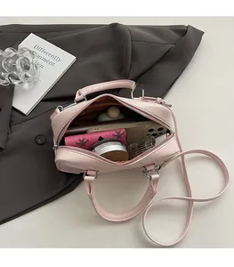 Internal view of pink leather boston bag showing spacious capacity for daily essentials