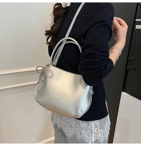 Silver PU leather bucket bag with metallic finish and decorative bow bead charm details