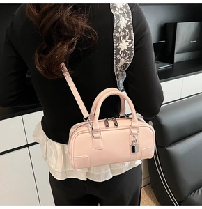 Pink rectangular handbag with silver padlock detail shown from a back-view model perspective