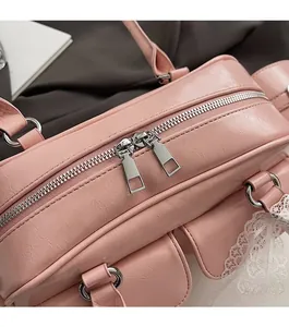 Detail view of pink Boston bag with smooth dual zippers and delicate lace trim accents