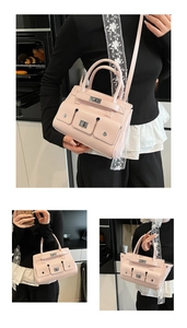 Detail of pink cargo style satchel with pockets, metal turn-locks and detachable shoulder strap