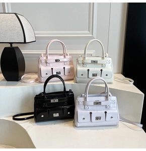 Detailed view of four colorful multi-pocket tote bags with silver metal turn-lock buckles