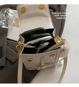 Detail view of the spacious interior of this elegant white PU leather crossbody bag