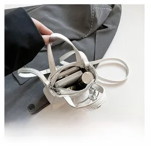 Top view of white pebble leather bucket bag showing interior space for phone and makeup