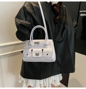 Detail of lavender leather handbag with triple front pockets and silver twist locks