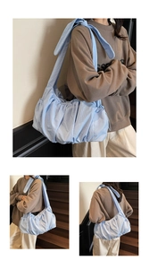 Macro detail of soft pleated fabric and shoulder knot on the light blue cloud tote bag