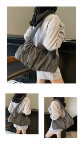 Detail view of large charcoal pleated cloud bag with vertical ruffles and wide strap