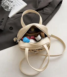 Top view of cream crossbody bag interior showing spacious storage for cosmetics