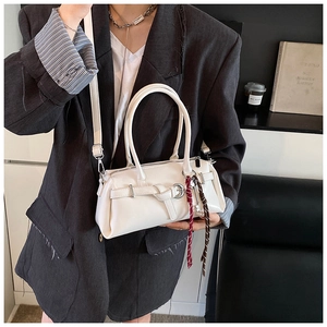 Chic white PU leather handbag with woven detail, worn with a dark grey office blazer