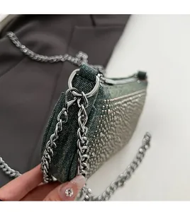 Detail of vintage denim bag with sparkling rhinestones and thick silver chain strap