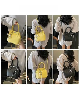 Detail view of yellow and black pebbled leather Kelly bags with silk ribbon and pearl charms
