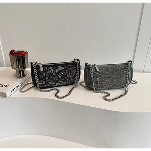 Detailed view of silver and black rhinestone underarm bags with elegant chain straps