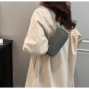 Chic silver rhinestone shoulder bag with metal chain strap shown on a khaki coat