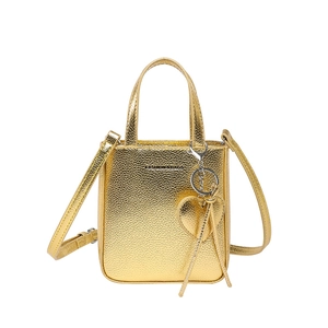 Golden faux leather bucket bag with top handles and heart charm on white background