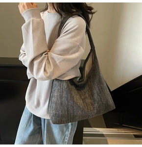 Detailed texture of charcoal grey denim tote bag showing thick canvas fabric and strap