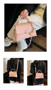 Detail of pink lychee leather handbag with silver chain heart charm and shoulder strap