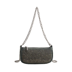 Retro denim underarm bag with silver rivets and metallic chain strap on white background