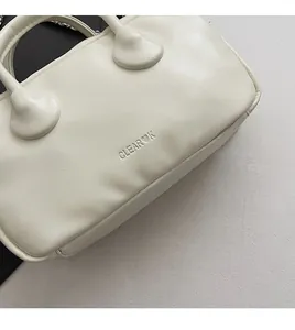 Detail of white PU leather bowling bag with CLEAR OK embossed logo and chain strap