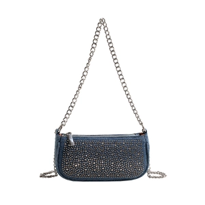 Chic blue denim underarm bag with metal rivets and silver chain strap for women
