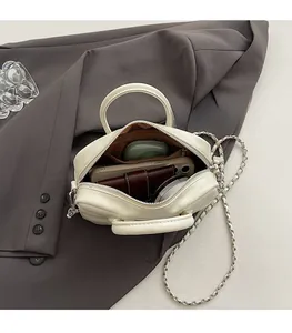 Top view of cream white bowling bag showing spacious interior with phone and wallet