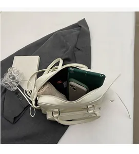 Interior view of spacious white leather pillow bag with tablet and daily essentials