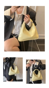 Detail of light yellow triangle handbag with wrinkled texture and metal chain strap