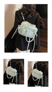 Detail of mint green multipurpose handbag featuring front zip pockets and smooth finish