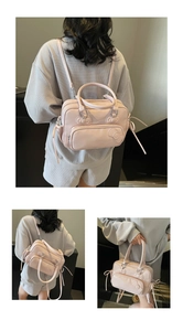 Detailed view of light pink pillow bag featuring cartoon silhouette and fringe tassels