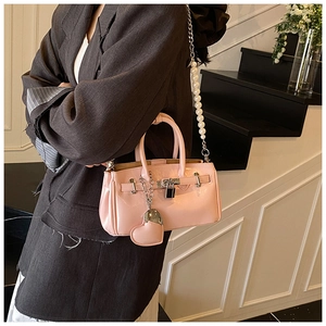 Detail of pink mini bucket bag with glossy finish and pearl chain shoulder strap