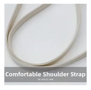 Detail of comfortable cream PU leather shoulder strap with fine reinforced stitching