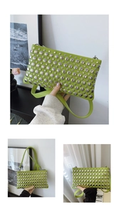 Detailed close-up of lime green handbag featuring silver metallic studs and sleek finish