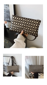 Detail of vintage brown leather bag with silver metallic rivets and adjustable strap