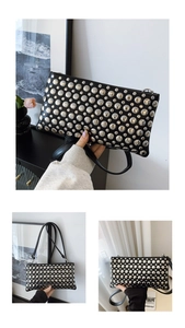 Detailed view of black PU leather shoulder bag with decorative silver studded rivets