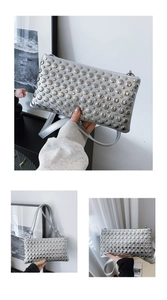 Detail of silver handbag with polished metal rivets and sleek zipper closure for punk style